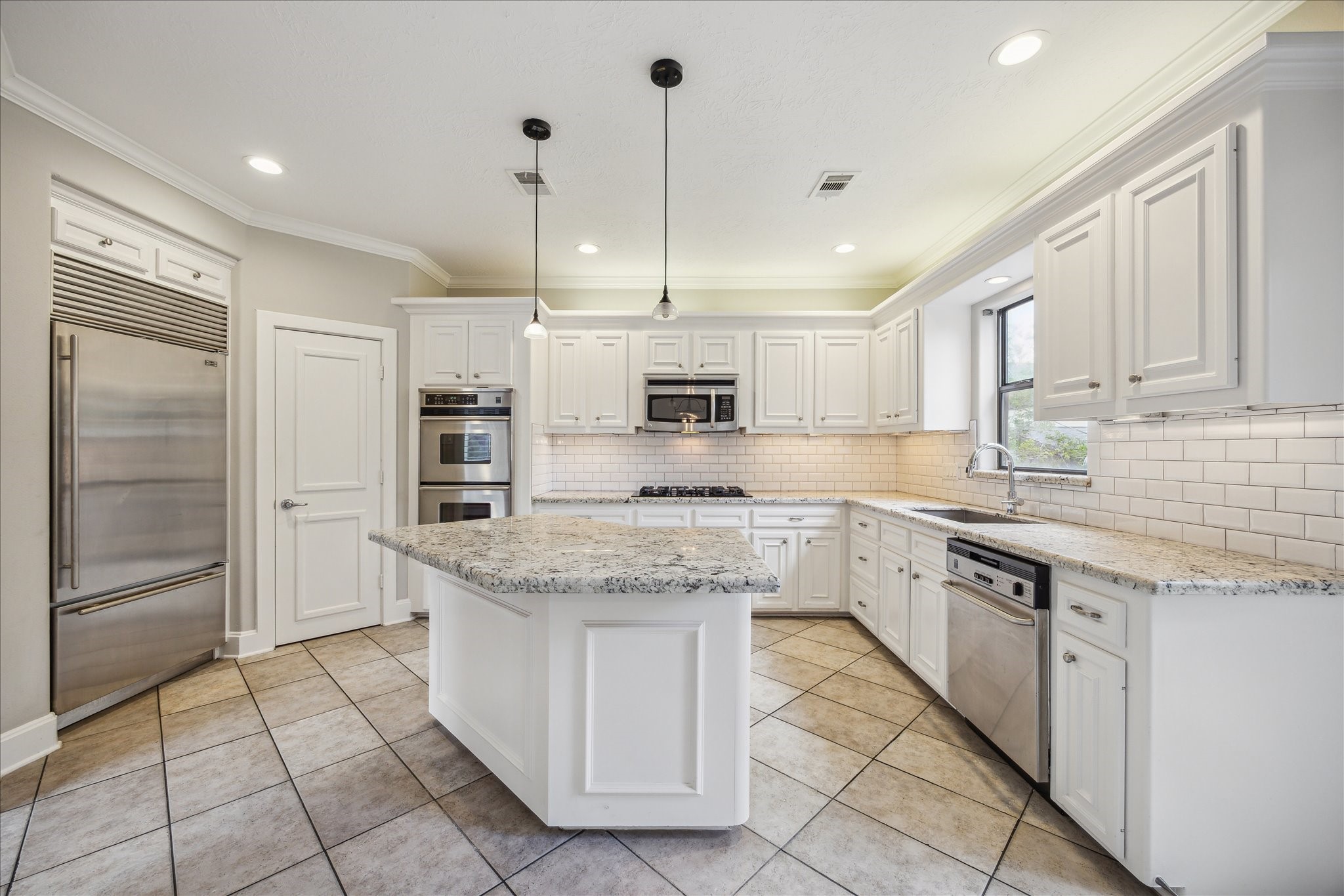 2817 Newman Street Houston, TX 77098 - Photo 16 of 36 a kitchen with stainless steel appliances granite countertop a sink and a refrigerator
