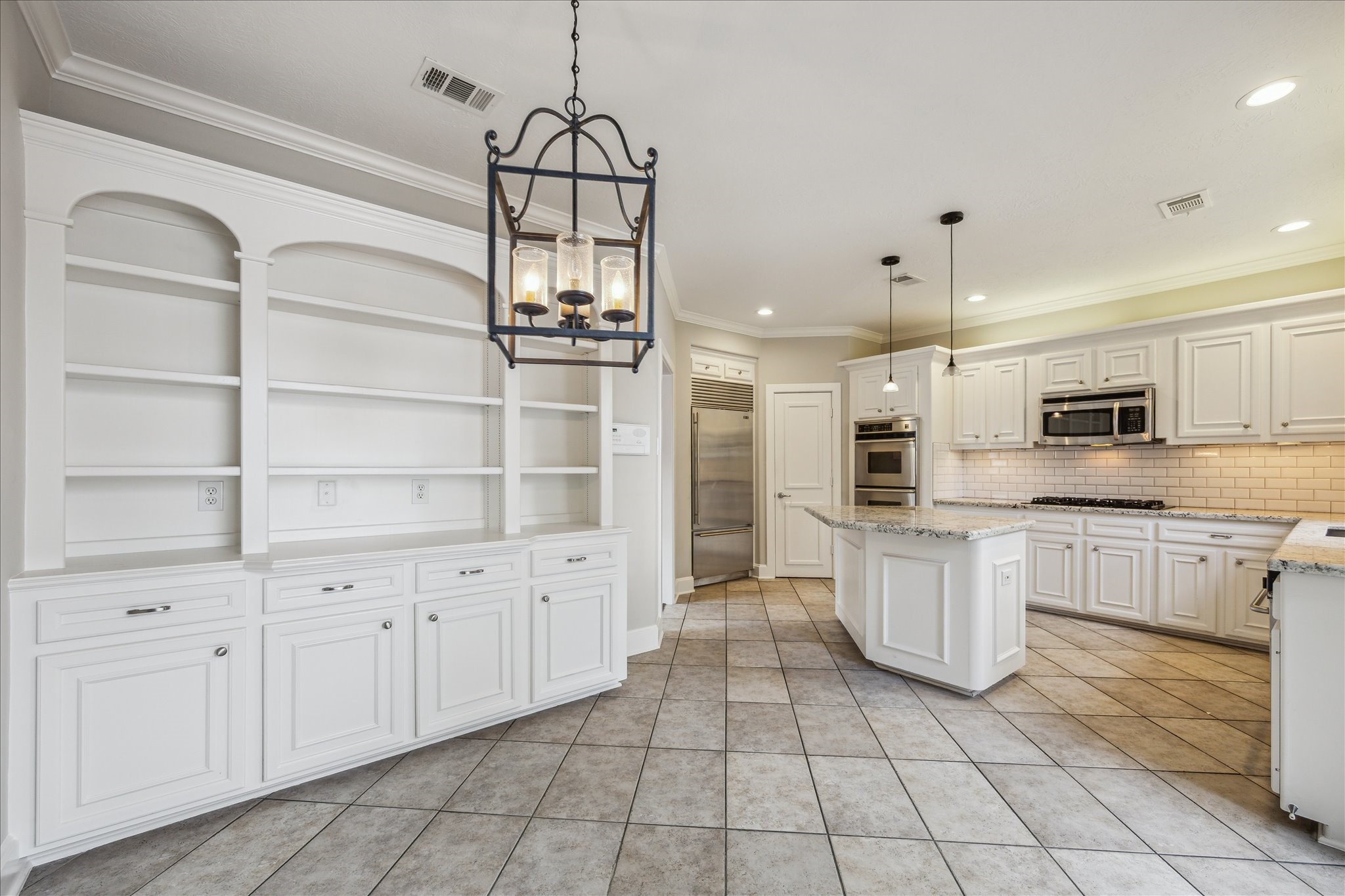 2817 Newman Street Houston, TX 77098 - Photo 17 of 36 a kitchen with white cabinets and appliances
