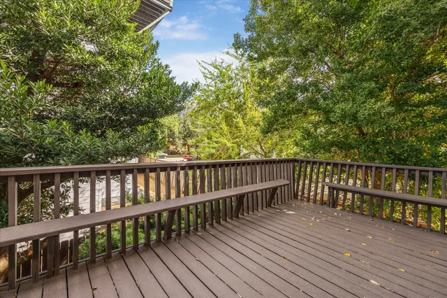 a balcony with wooden floor and fence