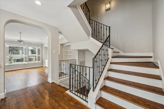 a view of staircase with wooden floor and a front door