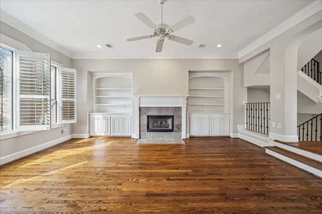 a view of an empty room with a fireplace and a window