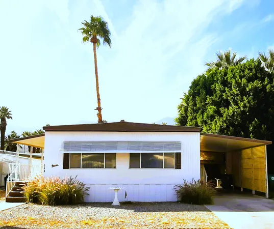 a front view of a house with a garden and yard