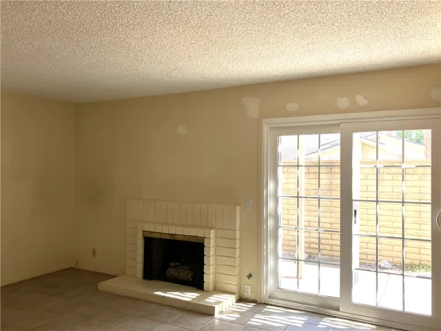 an empty room with a fireplace