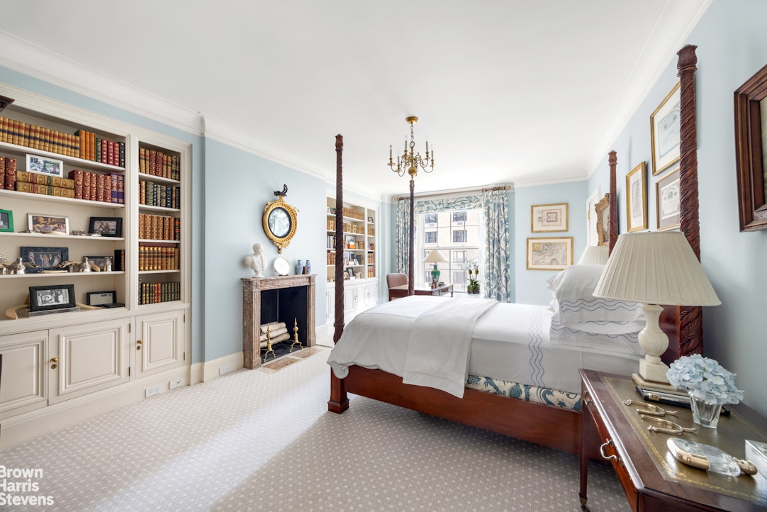 765 Park Avenue, Unit 6/7C Manhattan, NY 10021 - Photo 12 of 21 a bedroom with a bed and a chandelier