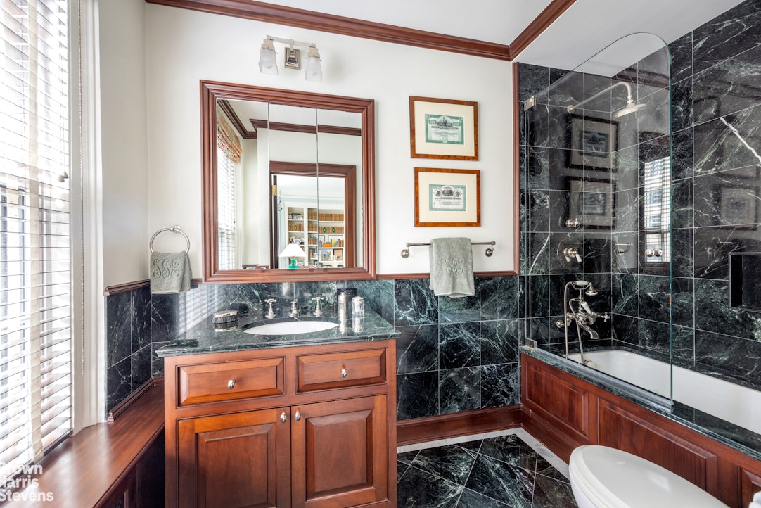 765 Park Avenue, Unit 6/7C Manhattan, NY 10021 - Photo 13 of 21 a bathroom with a sink a toilet and shower