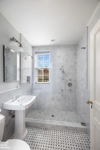 a bathroom with a sink toilet a shower and a mirror