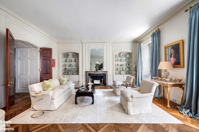 a living room with furniture and a large mirror