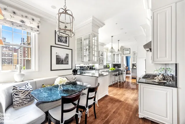 a living room with furniture a fireplace and a large window