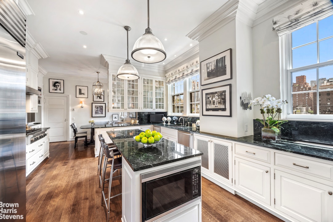 765 Park Avenue, Unit 6/7C Manhattan, NY 10021 - Photo 7 of 21 an open kitchen with granite countertop a stove and white cabinets