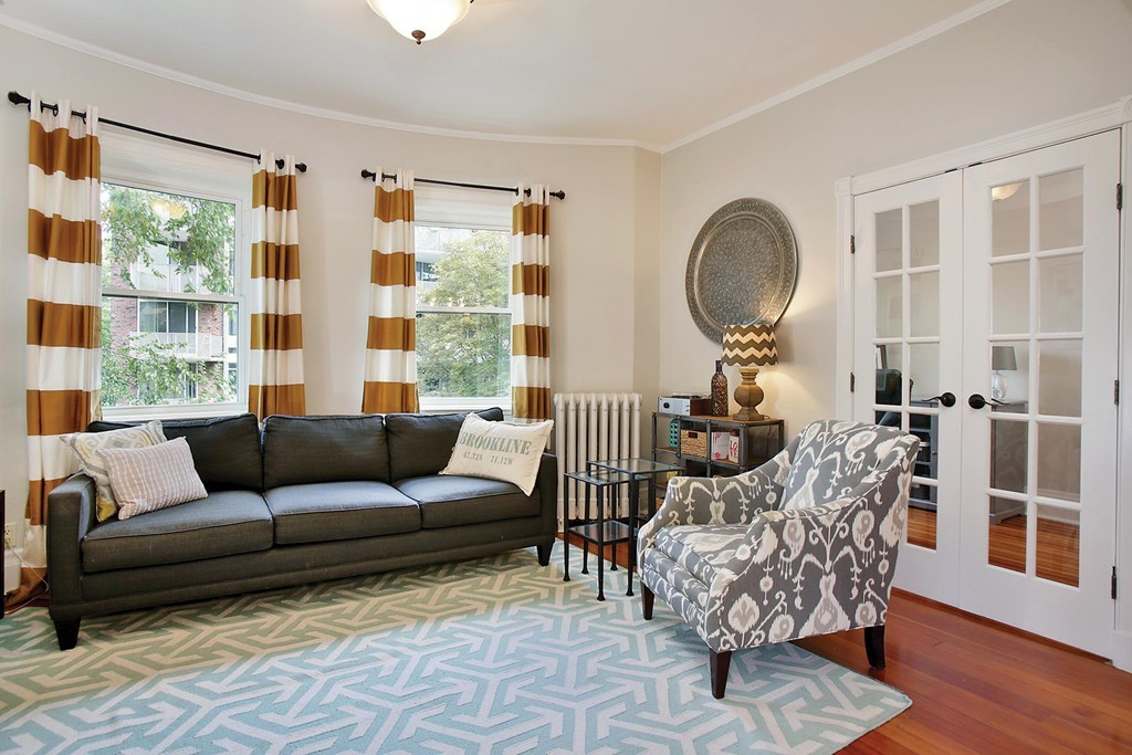 20 Winchester Street, Unit 8 Brookline, MA 02446 - Photo 2 of 8 a living room with furniture and a large window