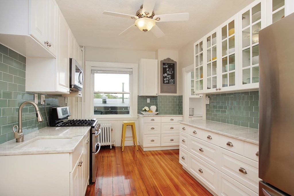 20 Winchester Street, Unit 8 Brookline, MA 02446 - Photo 4 of 8 a kitchen with a stove a sink and a refrigerator