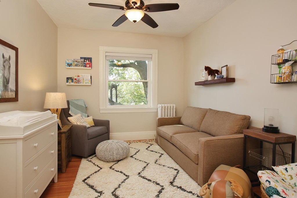20 Winchester Street, Unit 8 Brookline, MA 02446 - Photo 7 of 8 a living room with furniture and a window