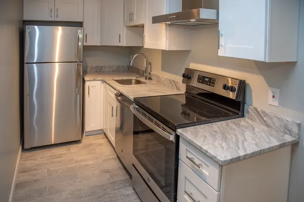 a kitchen with a stove sink and refrigerator