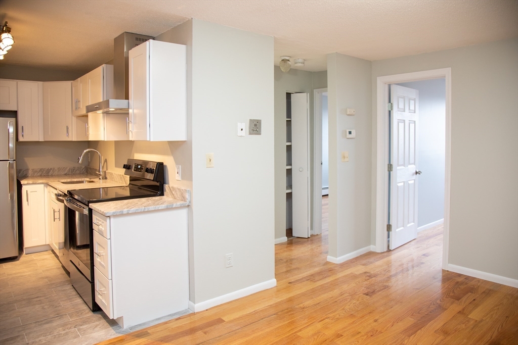 14 Murdock Street, Unit 37 Somerville, MA 02145 - Photo 3 of 11 a kitchen with a sink a stove and a refrigerator