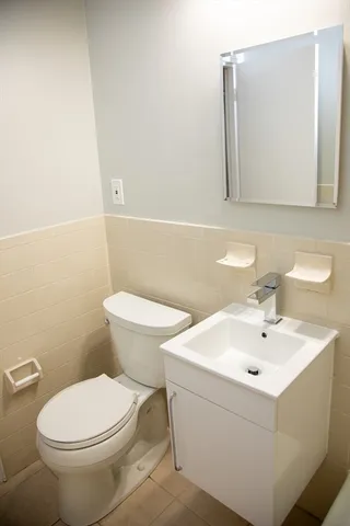 a white toilet sitting next to a bathroom sink
