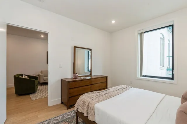 a bedroom with a bed and a lamp