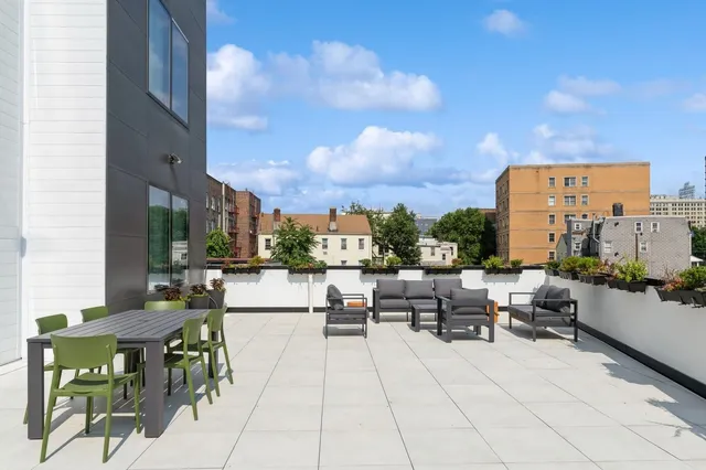 a living room with furniture potted plant and open windows