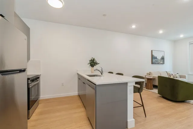 a kitchen with a sink and a refrigerator