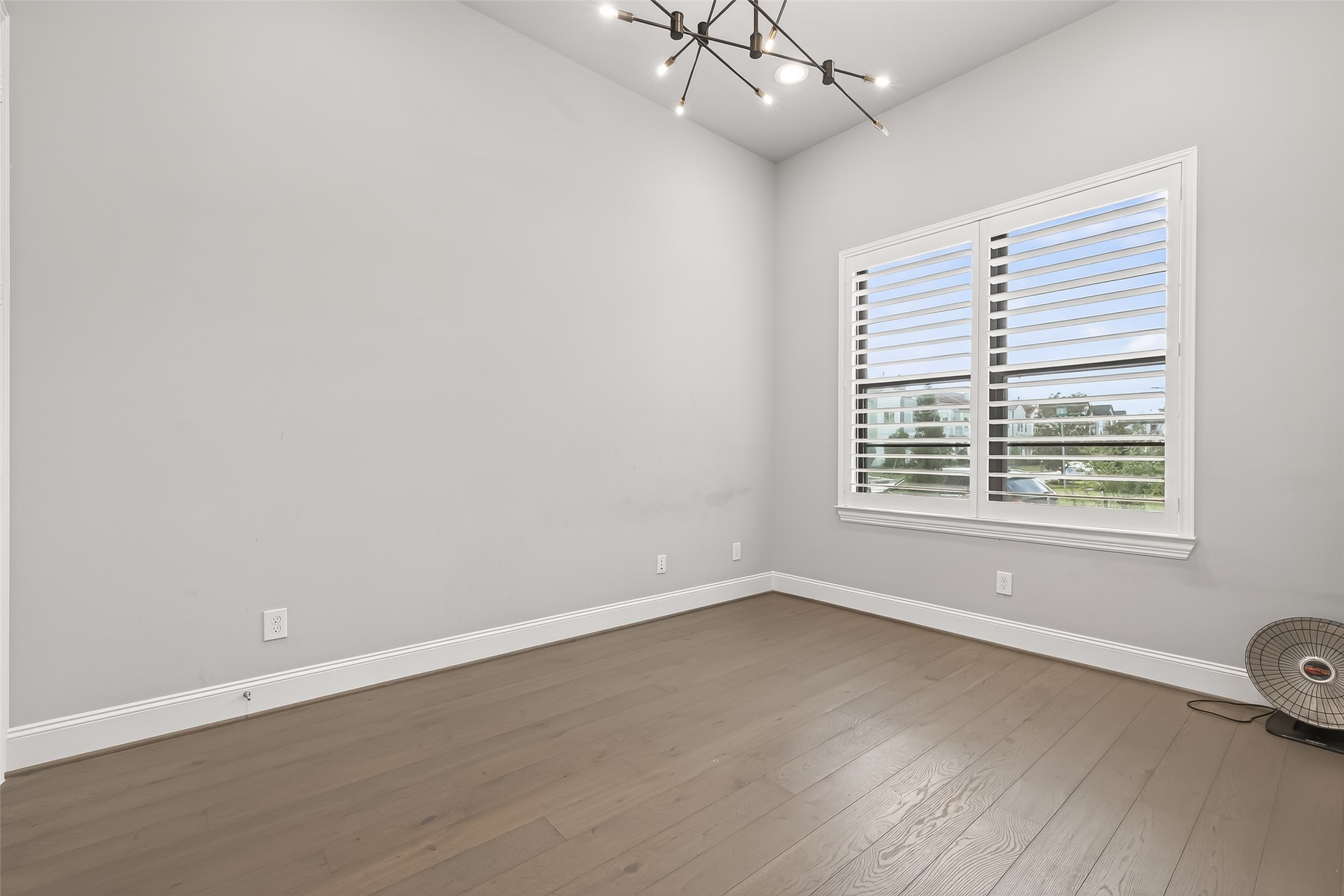 2435 Prairie Hollow Lane Houston, TX 77077 - Photo 14 of 50 an empty room with wooden floor and windows