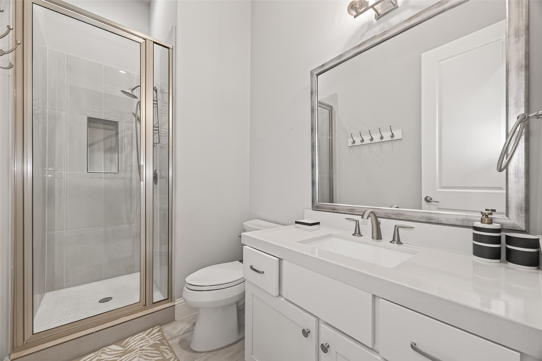 2435 Prairie Hollow Lane Houston, TX 77077 - Photo 16 of 50 a bathroom with a toilet a sink and a mirror