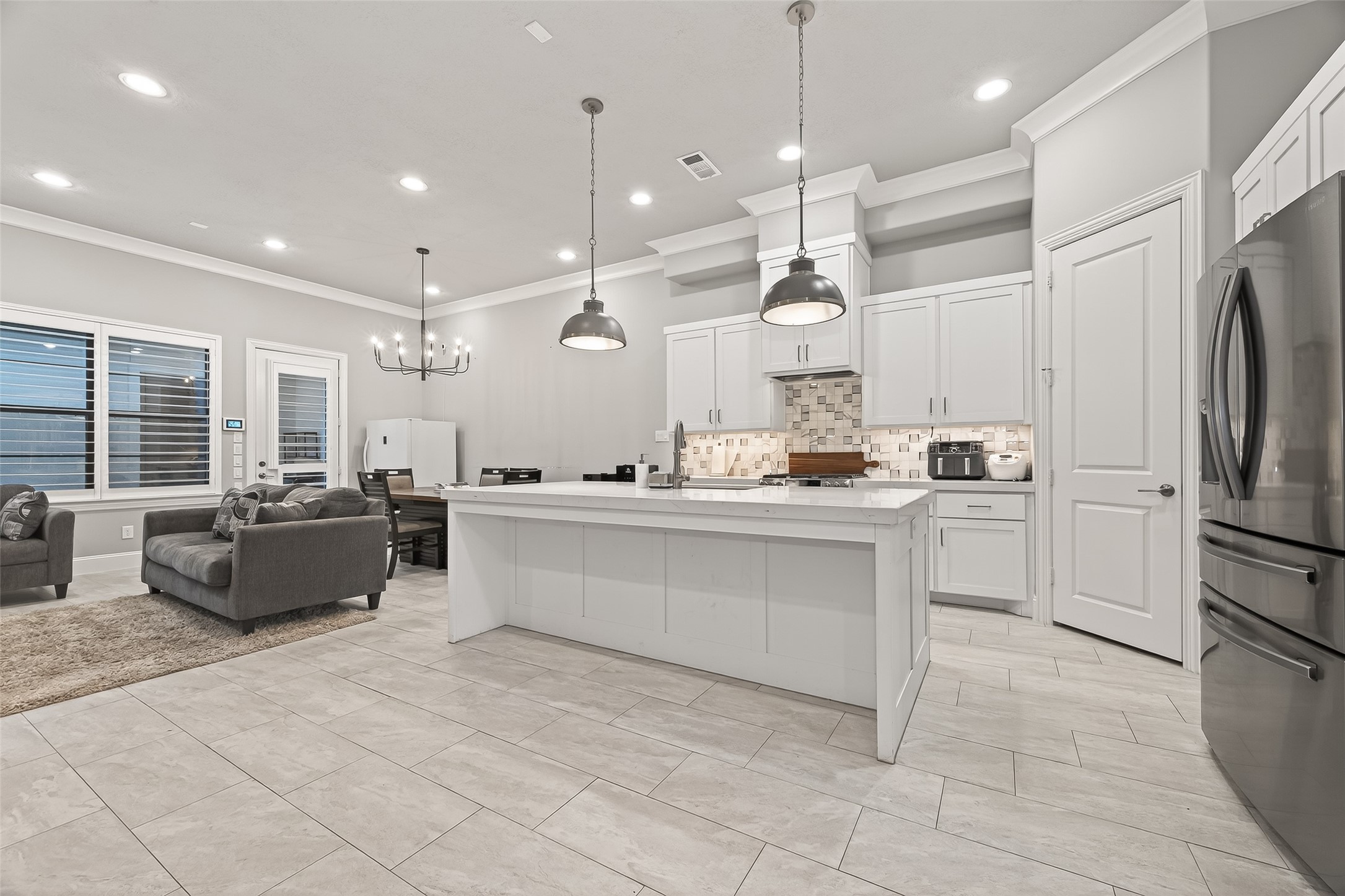 2435 Prairie Hollow Lane Houston, TX 77077 - Photo 20 of 50 a large white kitchen with a refrigerator a oven and a sink