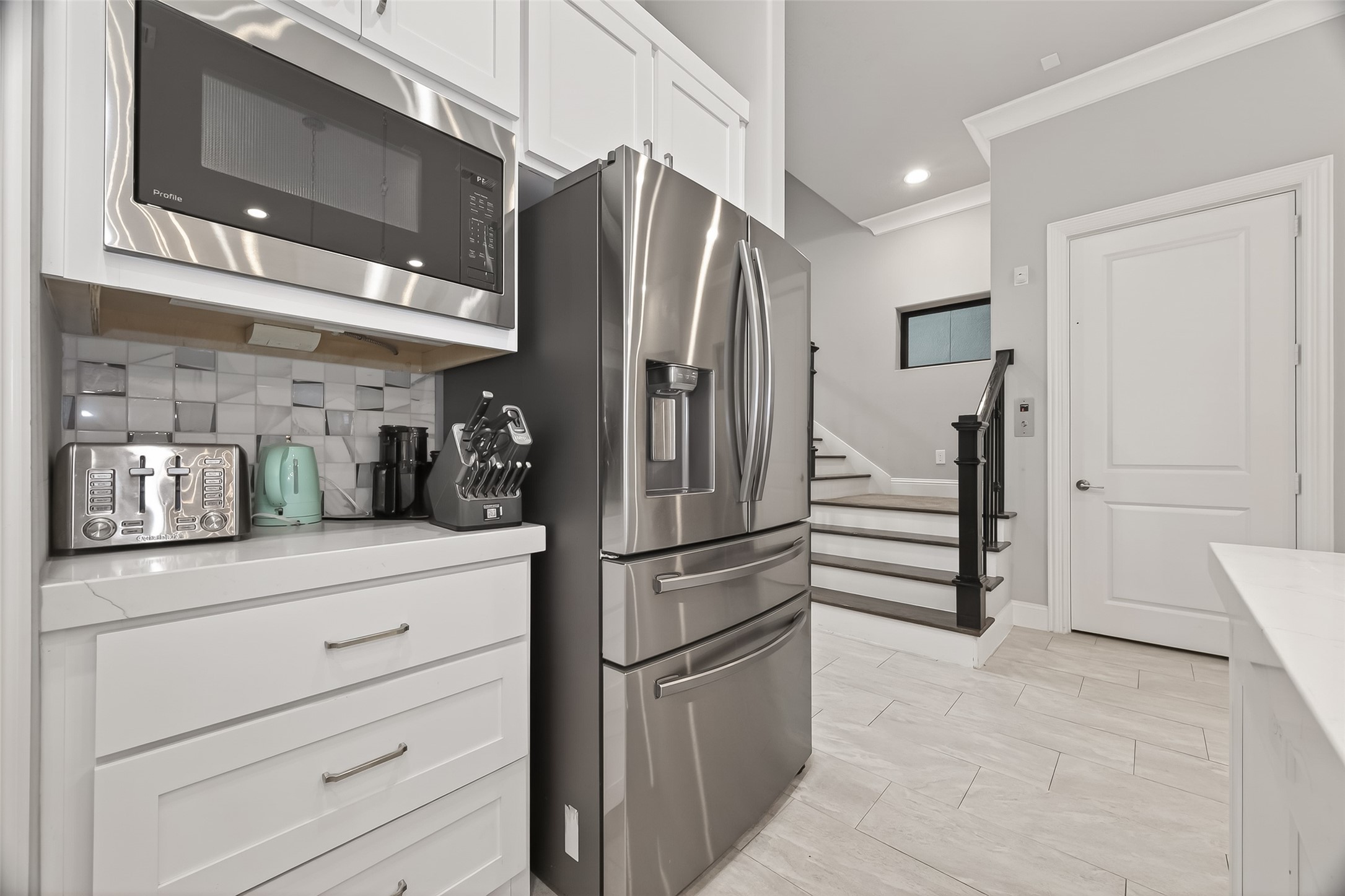 2435 Prairie Hollow Lane Houston, TX 77077 - Photo 24 of 50 a kitchen with stainless steel appliances a refrigerator and cabinets