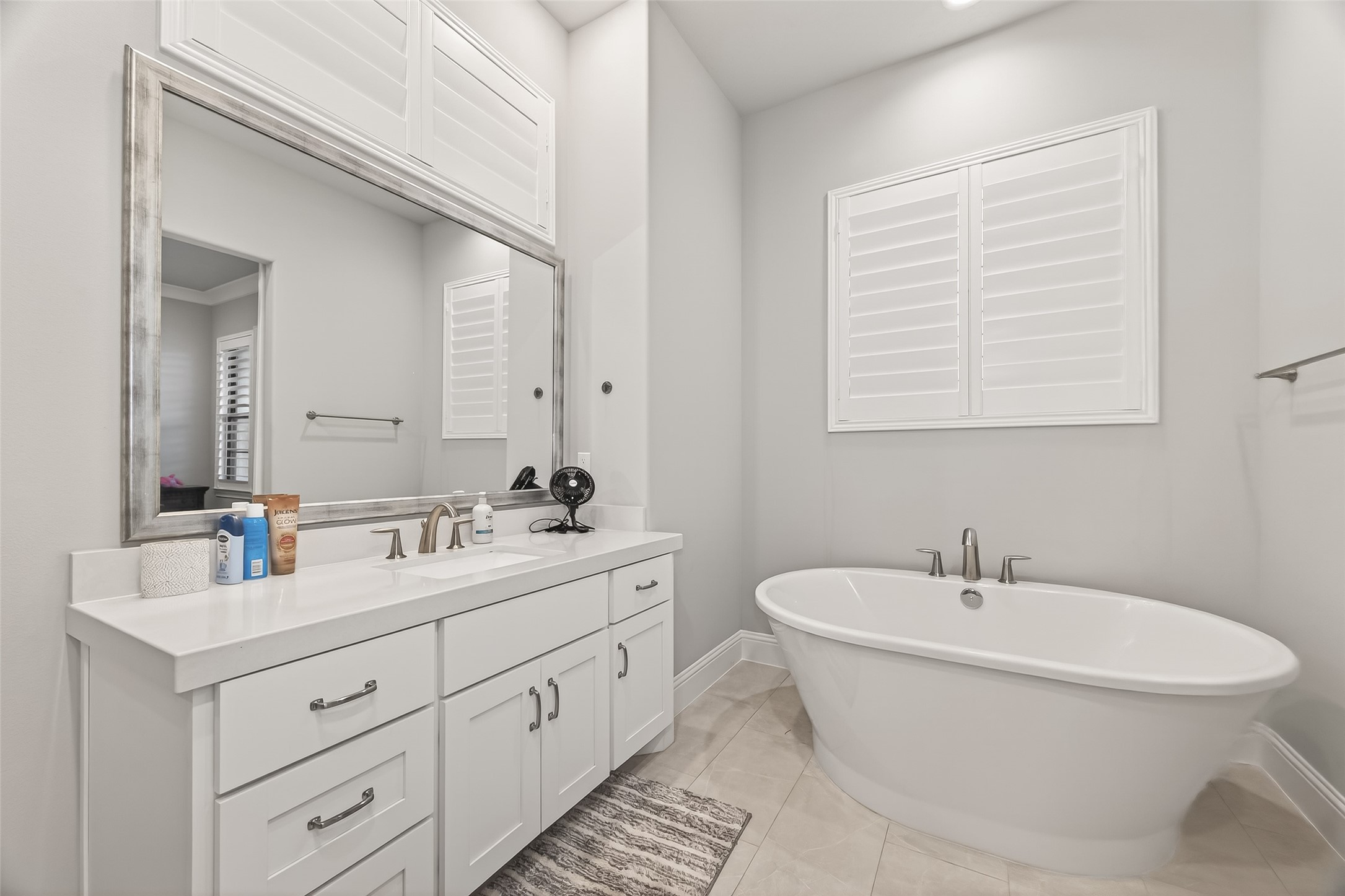 2435 Prairie Hollow Lane Houston, TX 77077 - Photo 29 of 50 a bathroom with double sink and a mirror