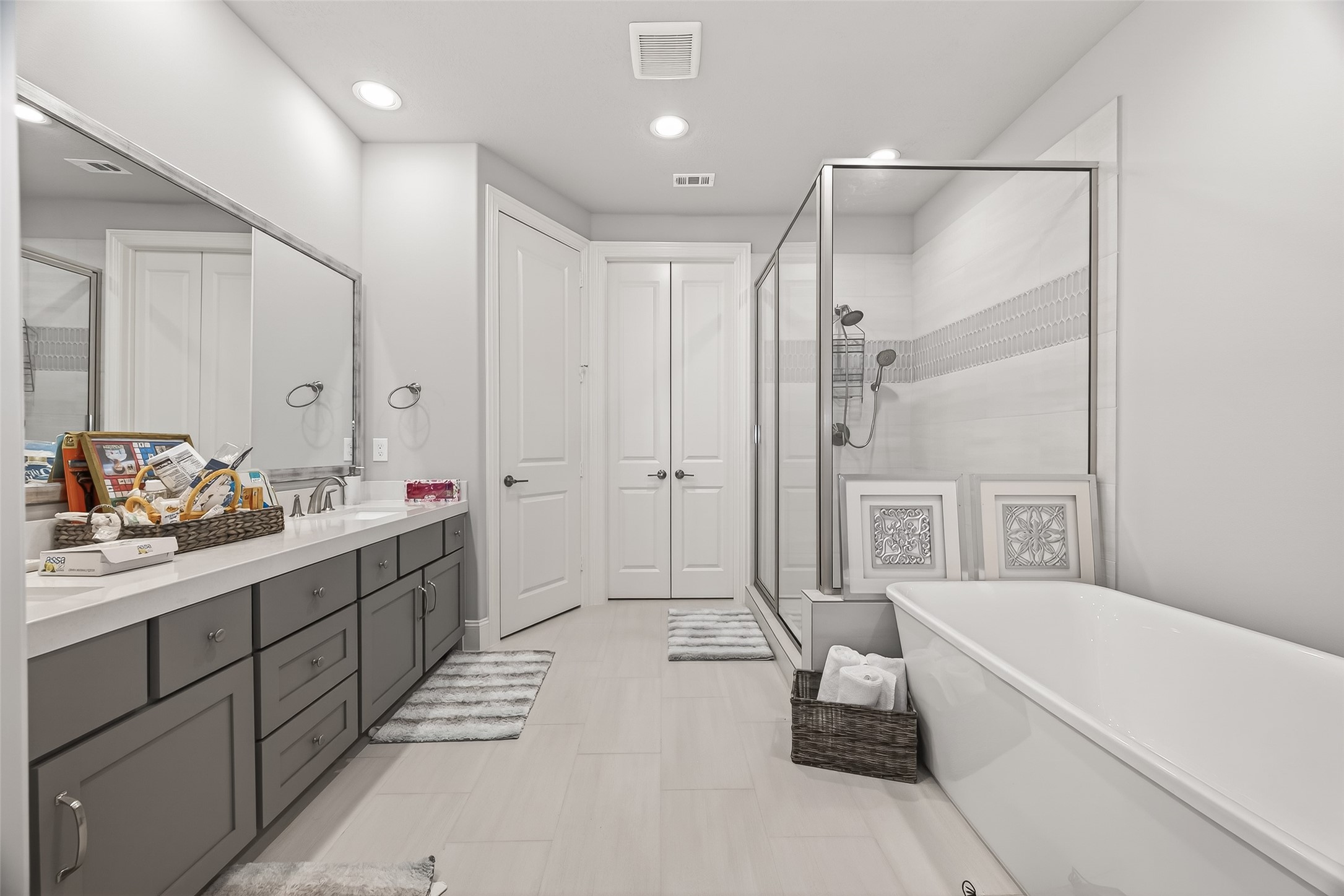 2435 Prairie Hollow Lane Houston, TX 77077 - Photo 37 of 50 a bathroom with a double vanity sink a mirror and a bathtub
