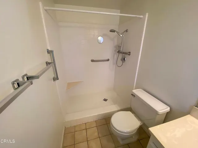 a white toilet sitting next to a bath tub