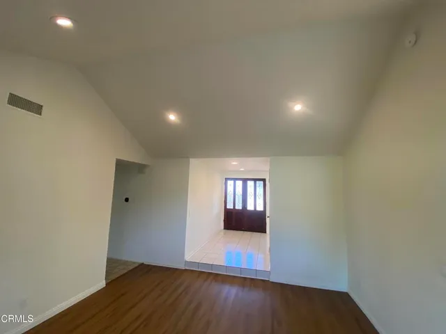 a view of wooden floor and windows in a room