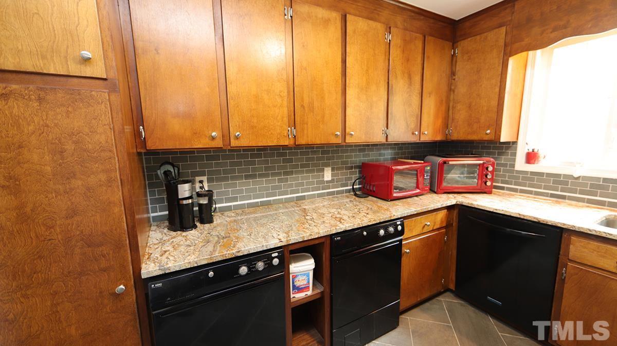 2947 Wycliff Road Raleigh, NC 27607 - Photo 5 of 11 a kitchen with stainless steel appliances granite countertop a sink a stove and a microwave
