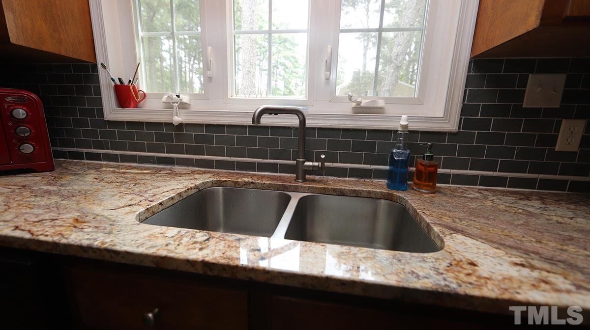 2947 Wycliff Road Raleigh, NC 27607 - Photo 10 of 11 a kitchen with a sink and a window