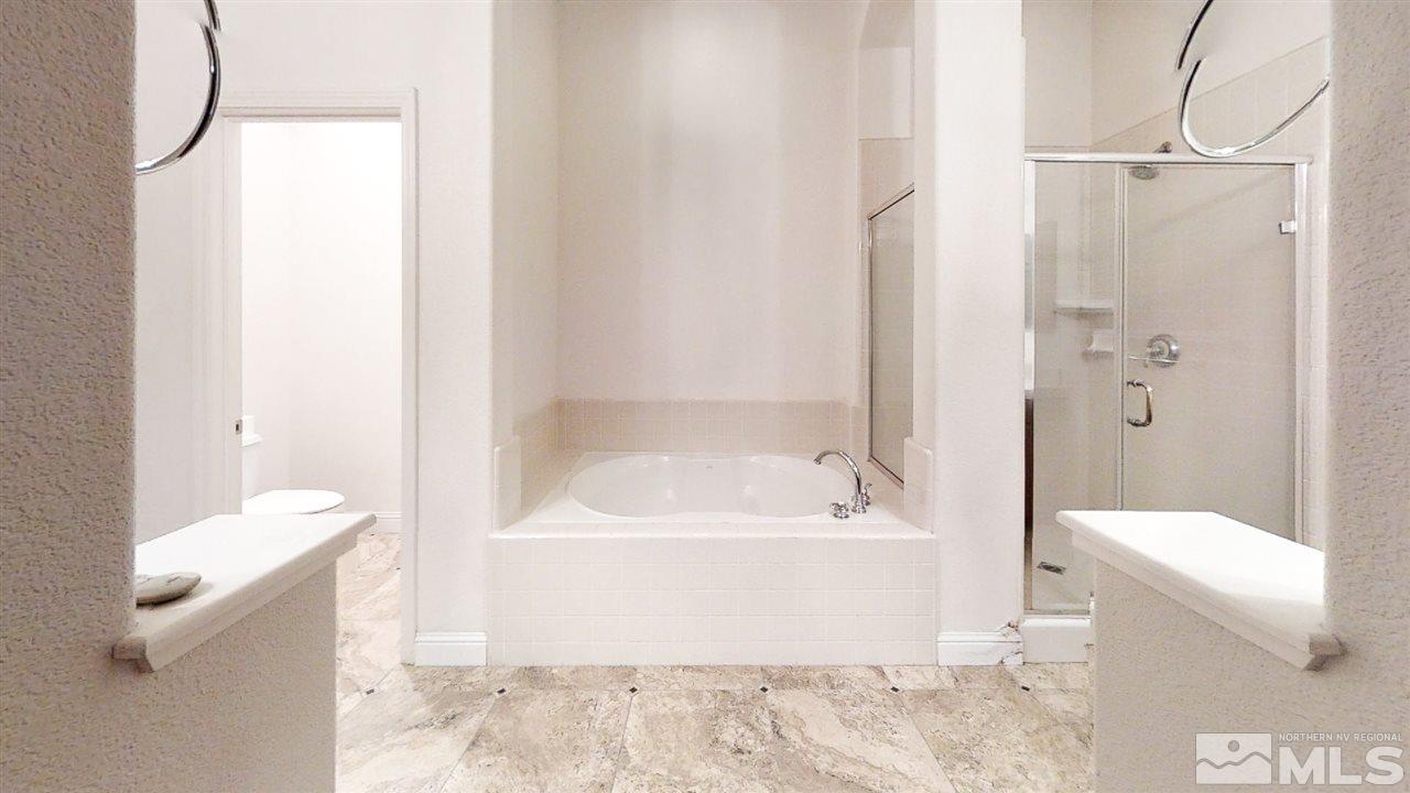 1695 Silver Thread Drive Reno, NV 89521 - Photo 12 of 15 a bathroom with a bathtub a toilet and a shower