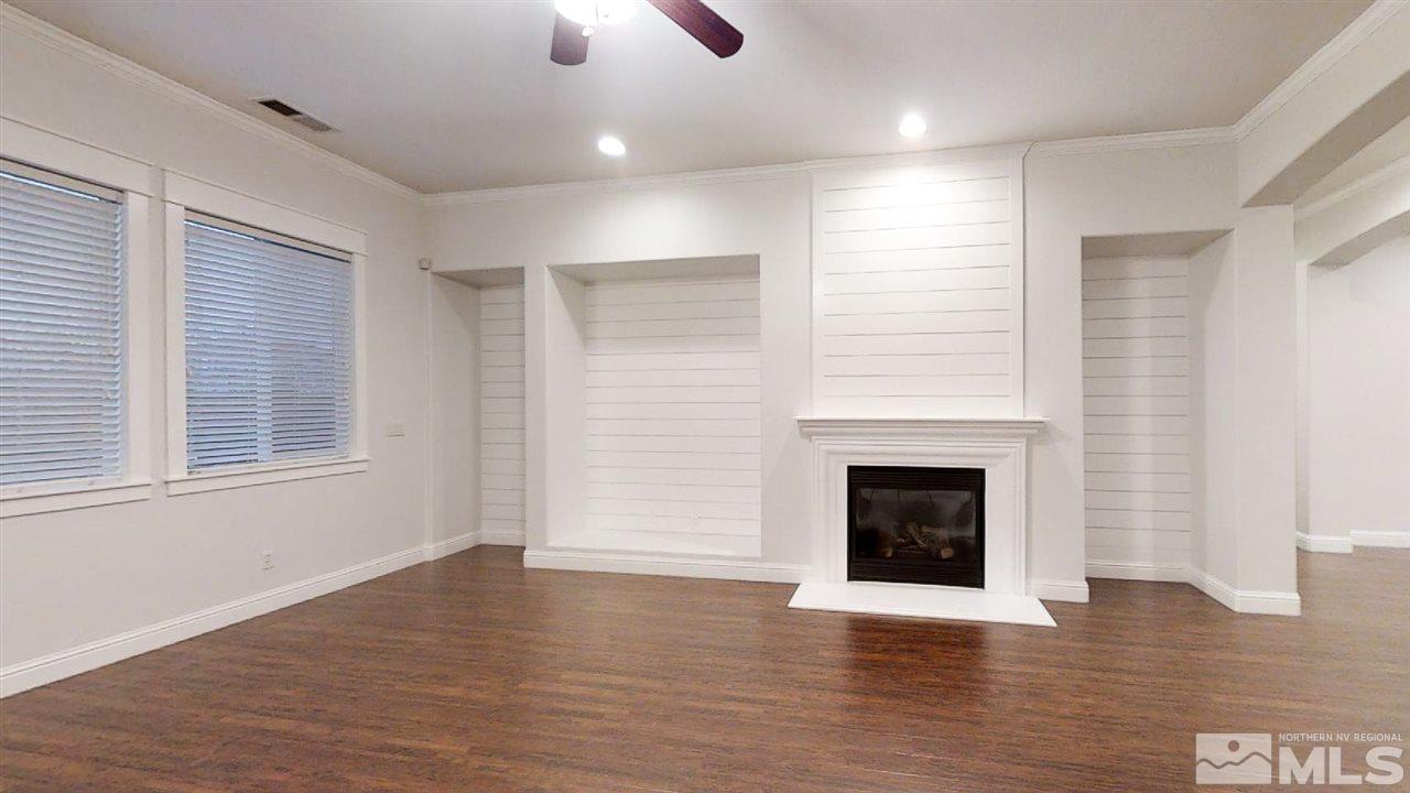1695 Silver Thread Drive Reno, NV 89521 - Photo 5 of 15 an empty room with wooden floor fireplace and windows