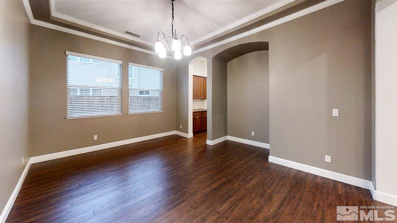 1695 Silver Thread Drive Reno, NV 89521 - Photo 7 of 15 a view of an empty room with wooden floor and a window