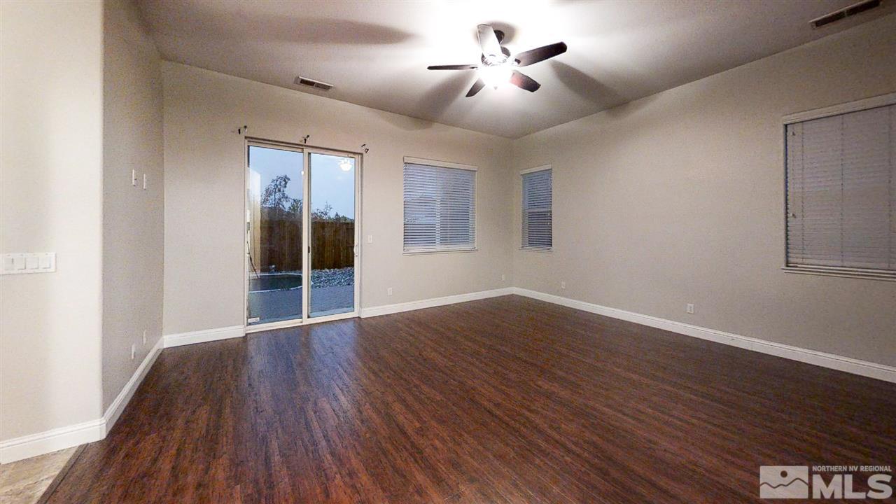 1695 Silver Thread Drive Reno, NV 89521 - Photo 10 of 15 a view of an empty room with wooden floor and a window