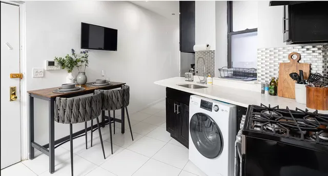 a utility room with sink washer and dryer