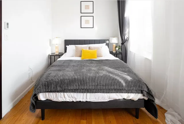 a bedroom with a bed and a mirror