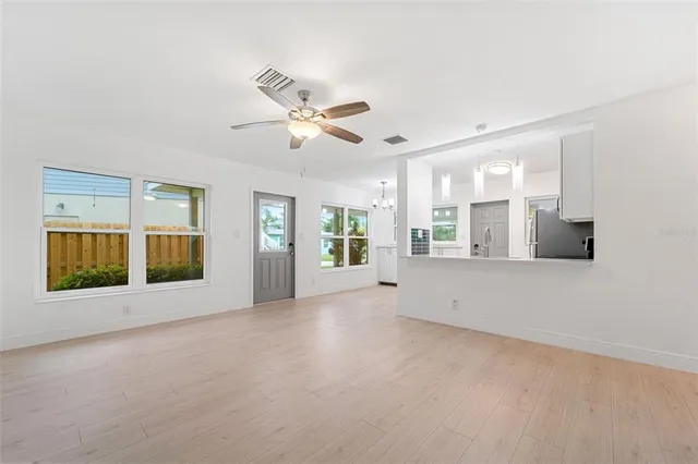 a view of an empty room with a window and fireplace