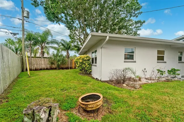 a backyard of a house with table and chairs
