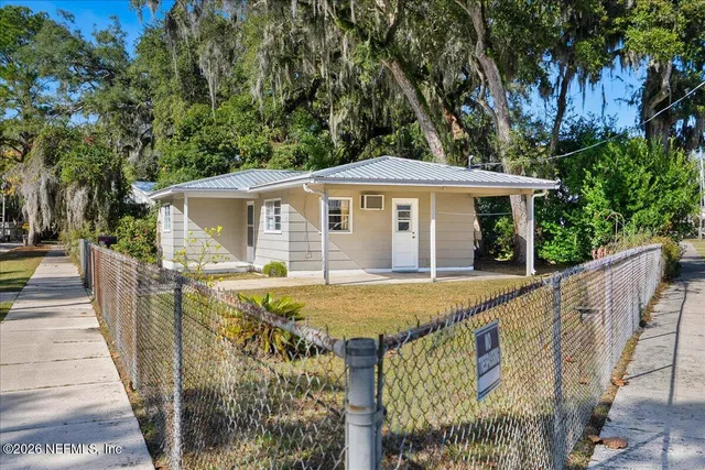 a view of a house with pool and trees