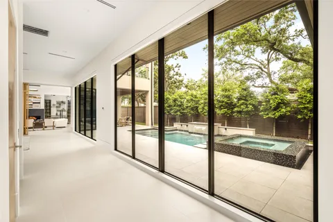 a view of a house with swimming pool next to a yard