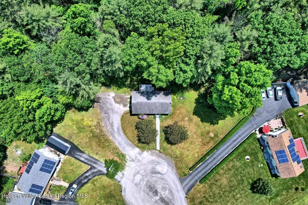 an aerial view of a house with a yard