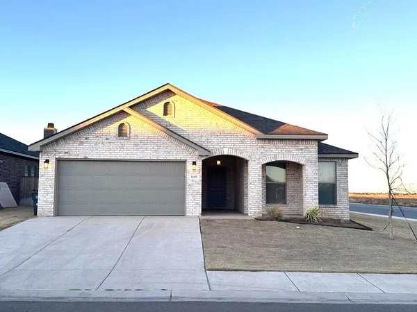a front view of a house with garage
