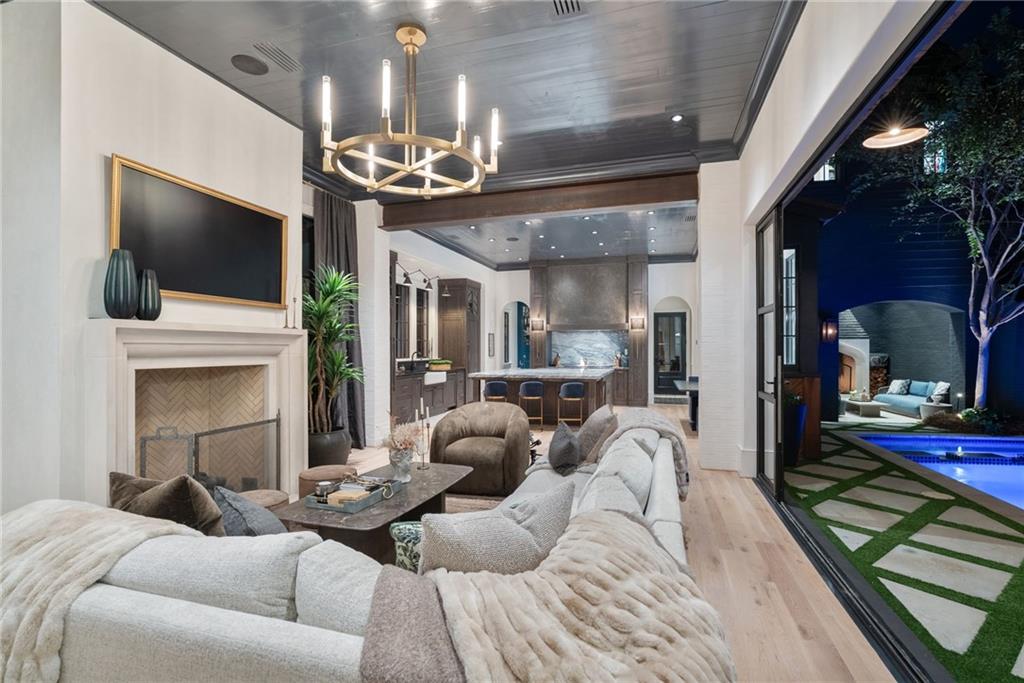 6570 Five Oaks Road Cumming, GA 30040 - Photo 29 of 136 a living room with furniture a fireplace and a flat screen tv
