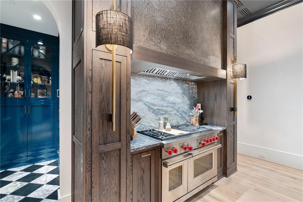 6570 Five Oaks Road Cumming, GA 30040 - Photo 37 of 136 a kitchen with stainless steel appliances granite countertop a stove and a wooden cabinets