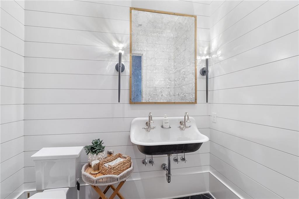 6570 Five Oaks Road Cumming, GA 30040 - Photo 43 of 136 a bathroom with a sink a toilet and a mirror