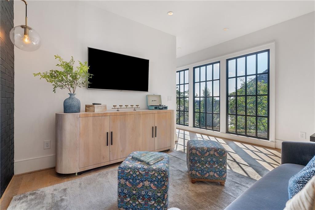 6570 Five Oaks Road Cumming, GA 30040 - Photo 54 of 136 a living room with furniture and a flat screen tv