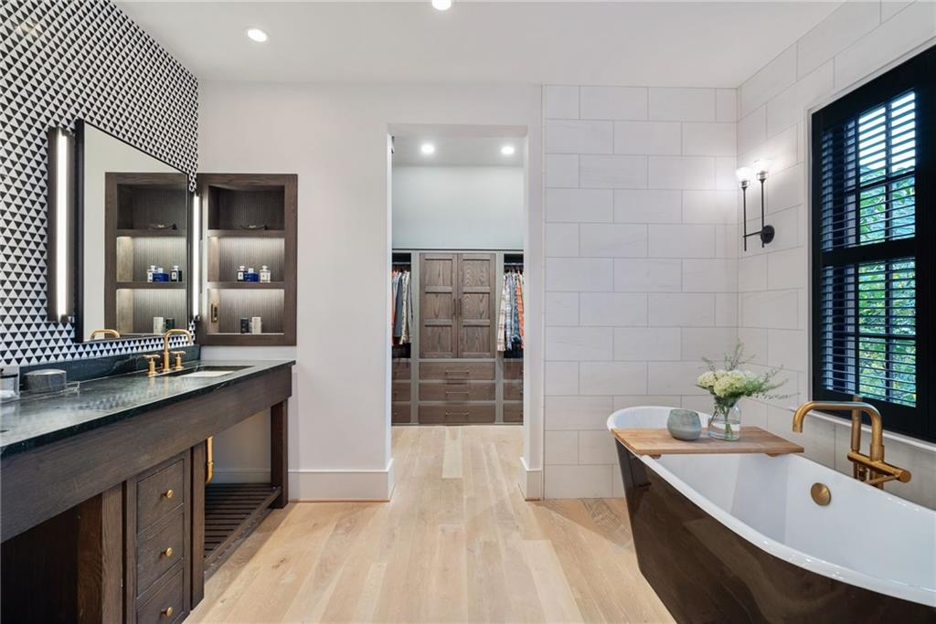 6570 Five Oaks Road Cumming, GA 30040 - Photo 60 of 136 a large bathroom with a double vanity sink a large mirror and a bathtub