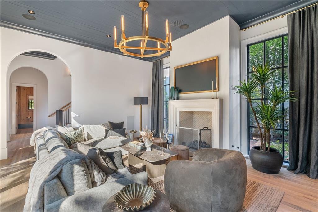 6570 Five Oaks Road Cumming, GA 30040 - Photo 7 of 136 a living room with furniture a fireplace and a flat screen tv